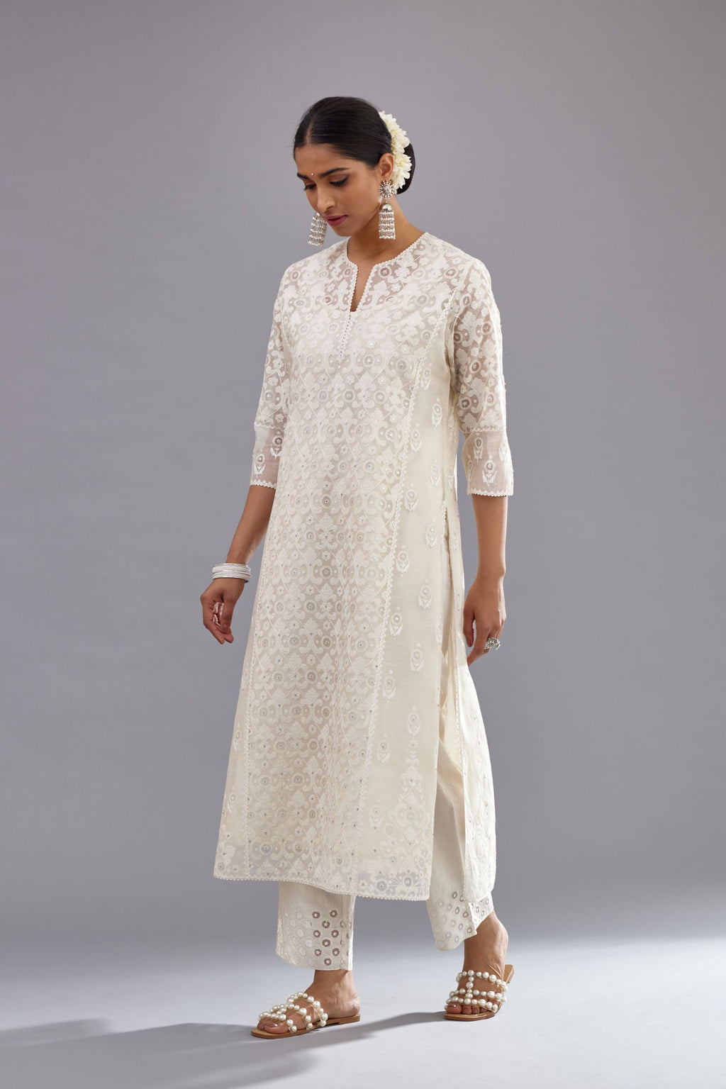 Off white silk chanderi straight kurta set with appliqué trellis jaal in center panel and small assorted flowers embroidery at side panells.
