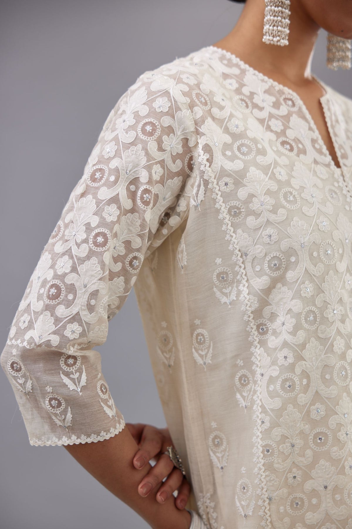 Off white silk chanderi straight kurta set with appliqué trellis jaal in center panel and small assorted flowers embroidery at side panells.