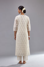 Off white silk chanderi straight kurta set with appliqué trellis jaal in center panel and small assorted flowers embroidery at side panells.