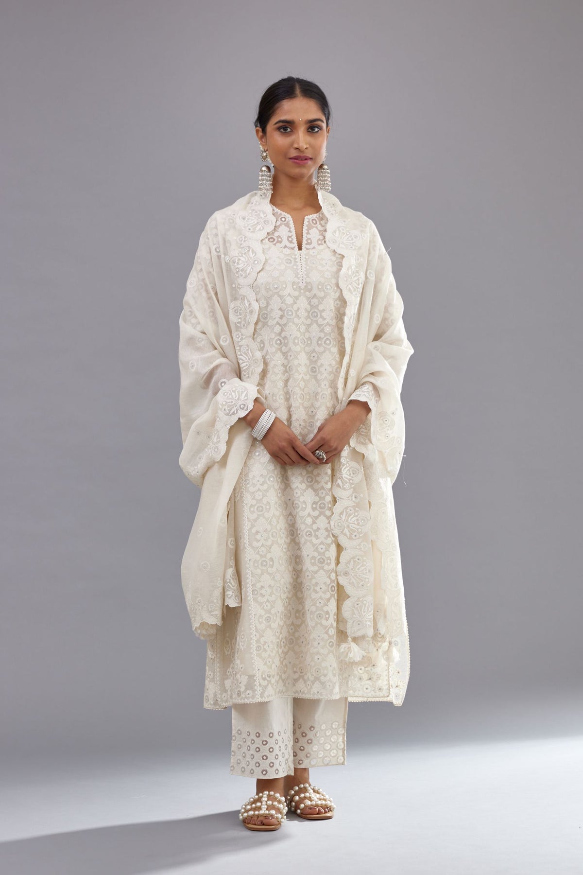 Off white silk chanderi straight kurta set with appliqué trellis jaal in center panel and small assorted flowers embroidery at side panells.