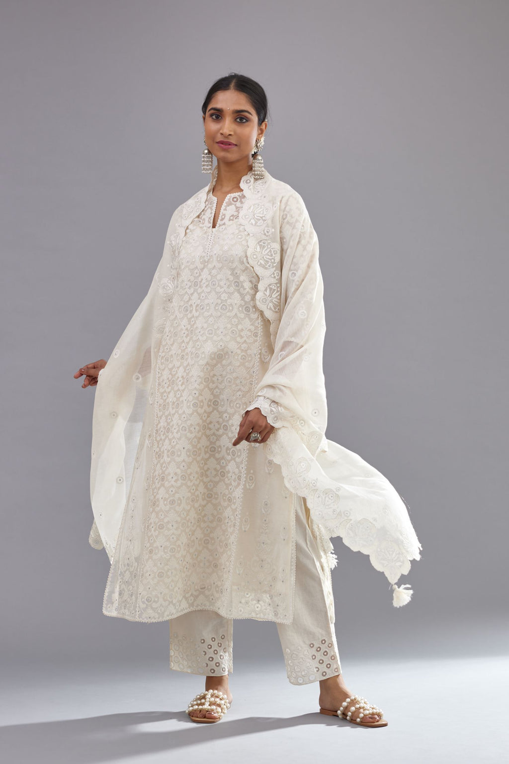 Off white silk chanderi straight kurta set with appliqué trellis jaal in center panel and small assorted flowers embroidery at side panells.