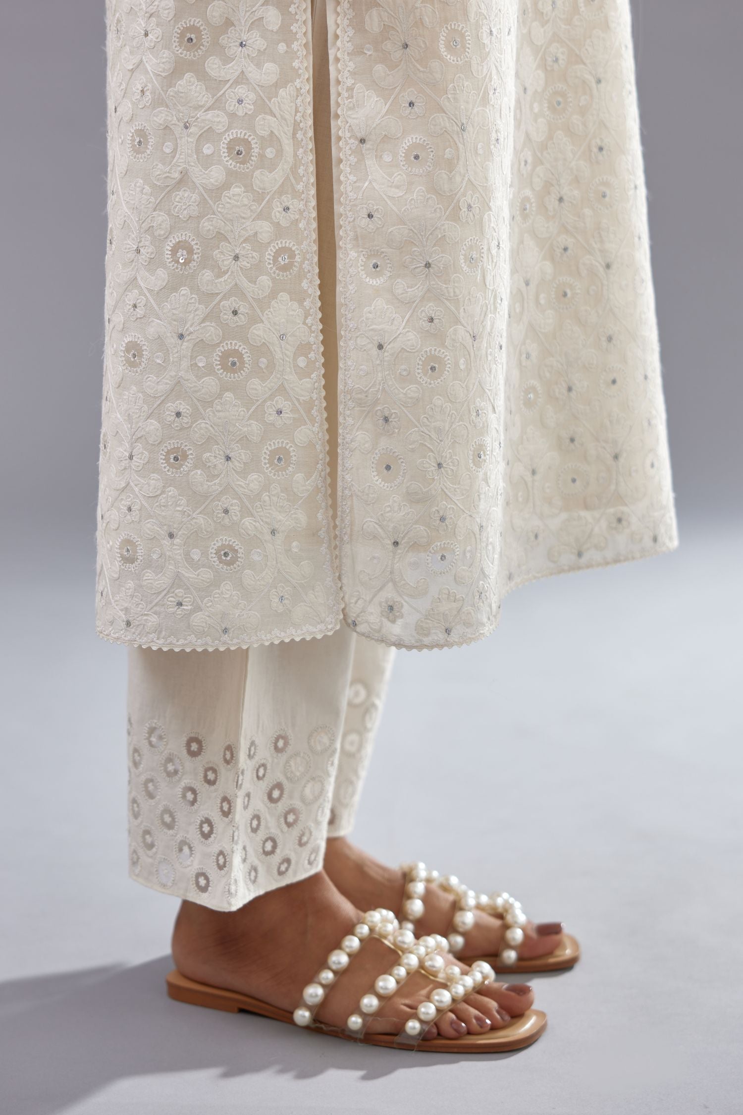 Off white straight kurta set with all-over cotton appliqué trellis jaal, highlighted with sequins.