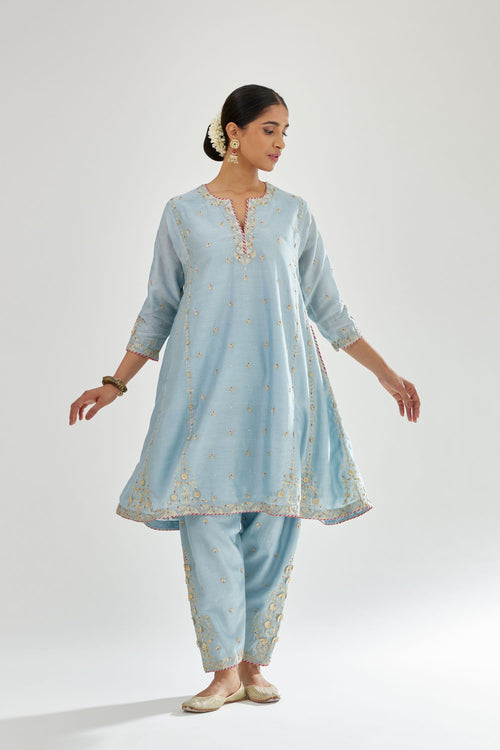 Blue silk chanderi short kalidar kurta set with all-over delicate zari bootis, detailed with dori embroidery and contrast bead work.