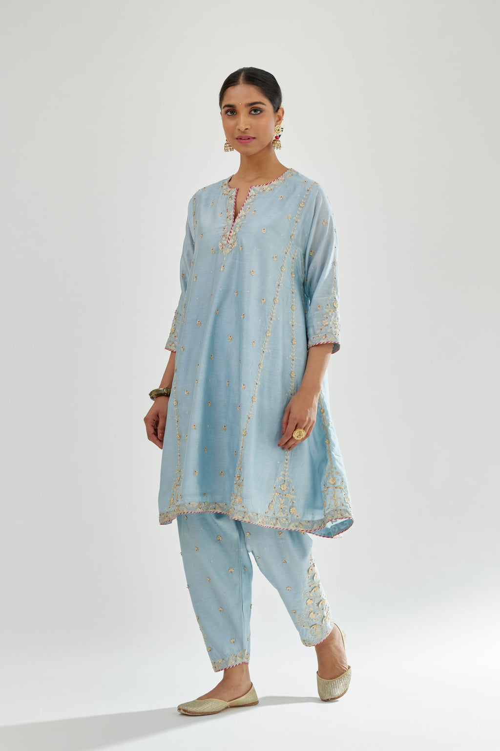 Blue silk chanderi short kalidar kurta set with all-over delicate zari bootis, detailed with dori embroidery and contrast bead work.