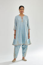 Blue silk chanderi short kalidar kurta set with all-over delicate zari bootis, detailed with dori embroidery and contrast bead work.