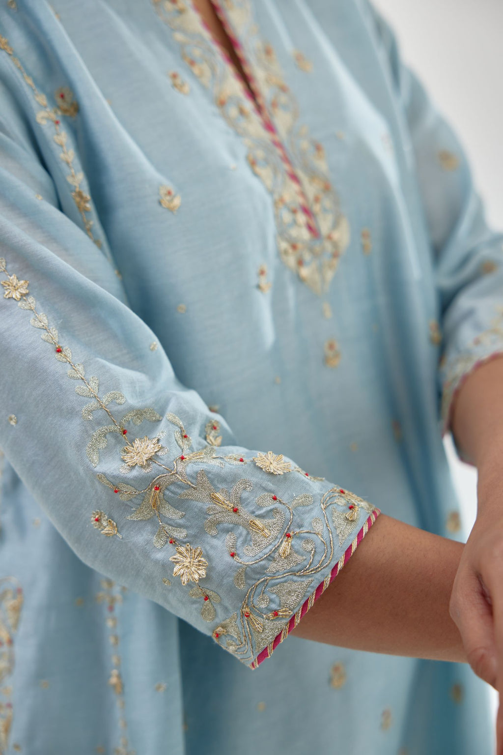 Blue silk chanderi short kalidar kurta set with all-over delicate zari bootis, detailed with dori embroidery and contrast bead work.