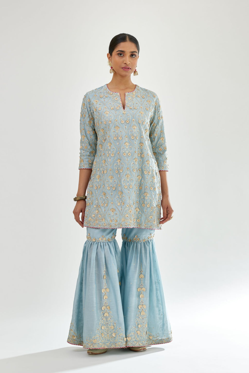 Blue short kurta set detailed with all-over zari, dori, sequins and gota embroidery.