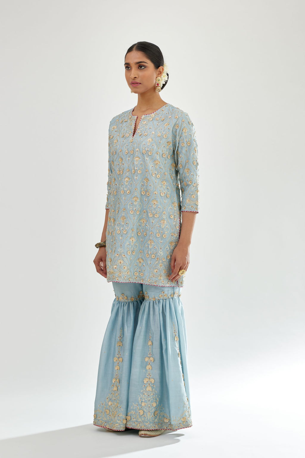 Blue short kurta set detailed with all-over zari, dori, sequins and gota embroidery.