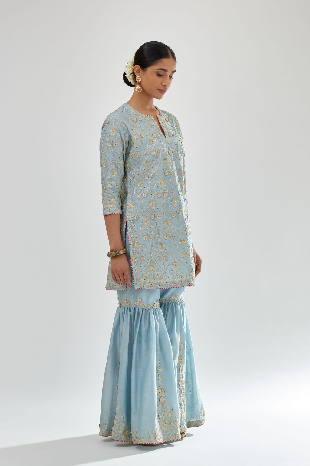 Blue short kurta set detailed with all-over zari, dori, sequins and gota embroidery.