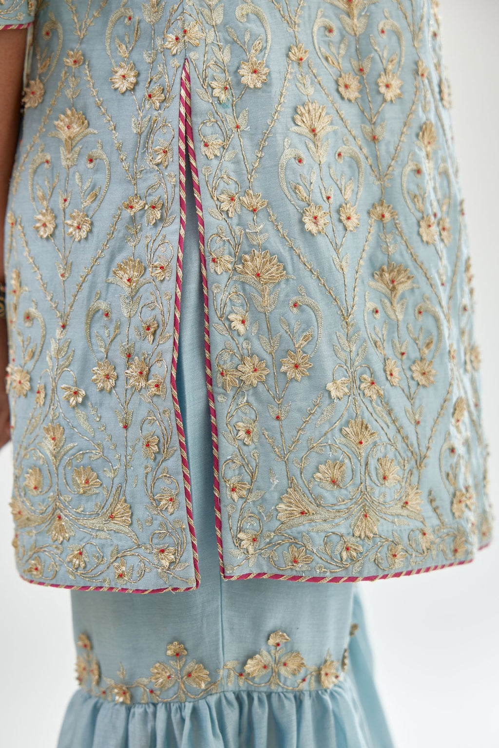 Blue short kurta set detailed with all-over zari, dori, sequins and gota embroidery.