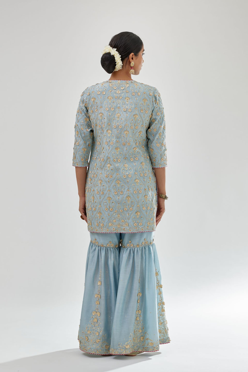 Blue short kurta set detailed with all-over zari, dori, sequins and gota embroidery.