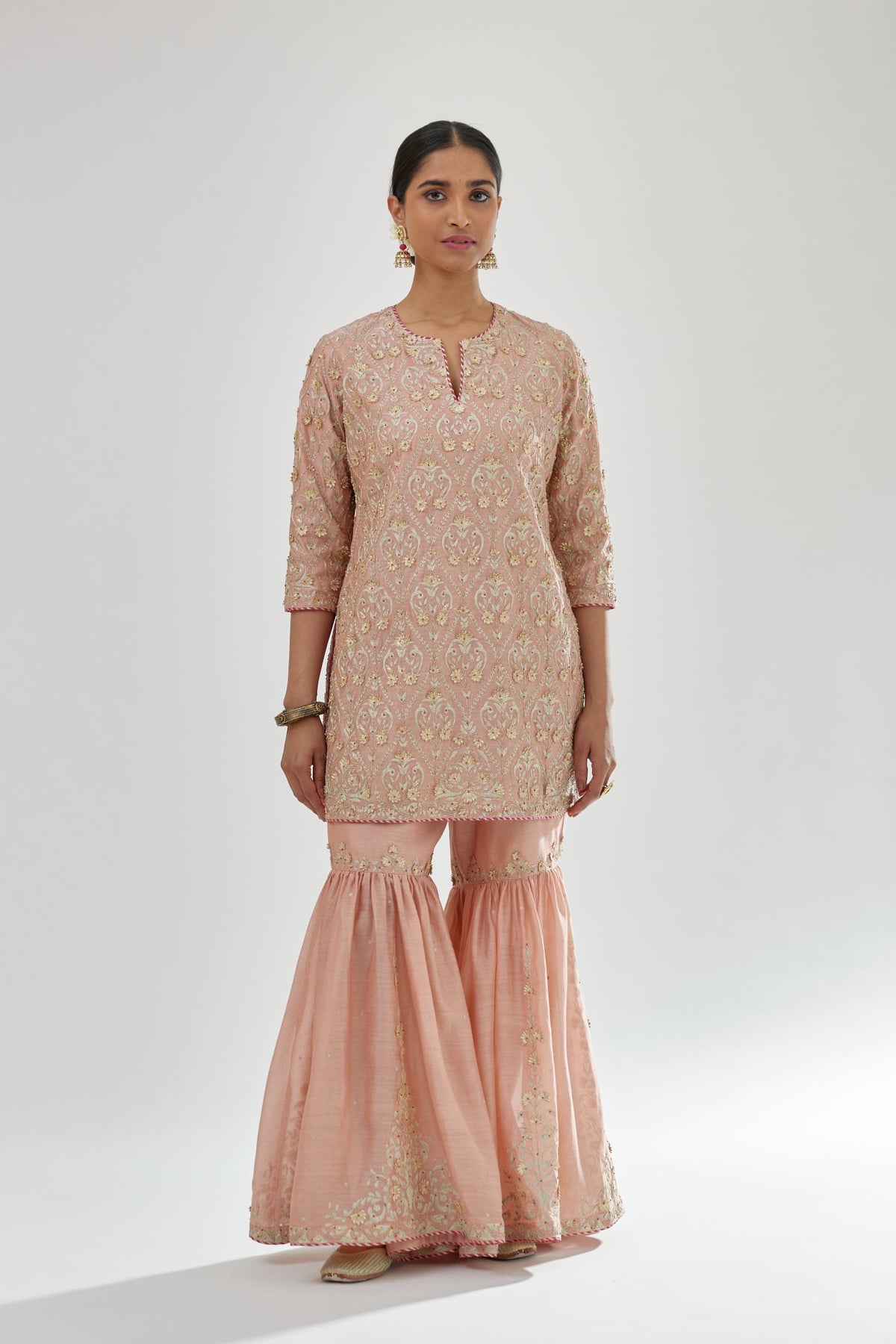 Pink short kurta set detailed with all-over zari, dori, sequins and gota embroidery.