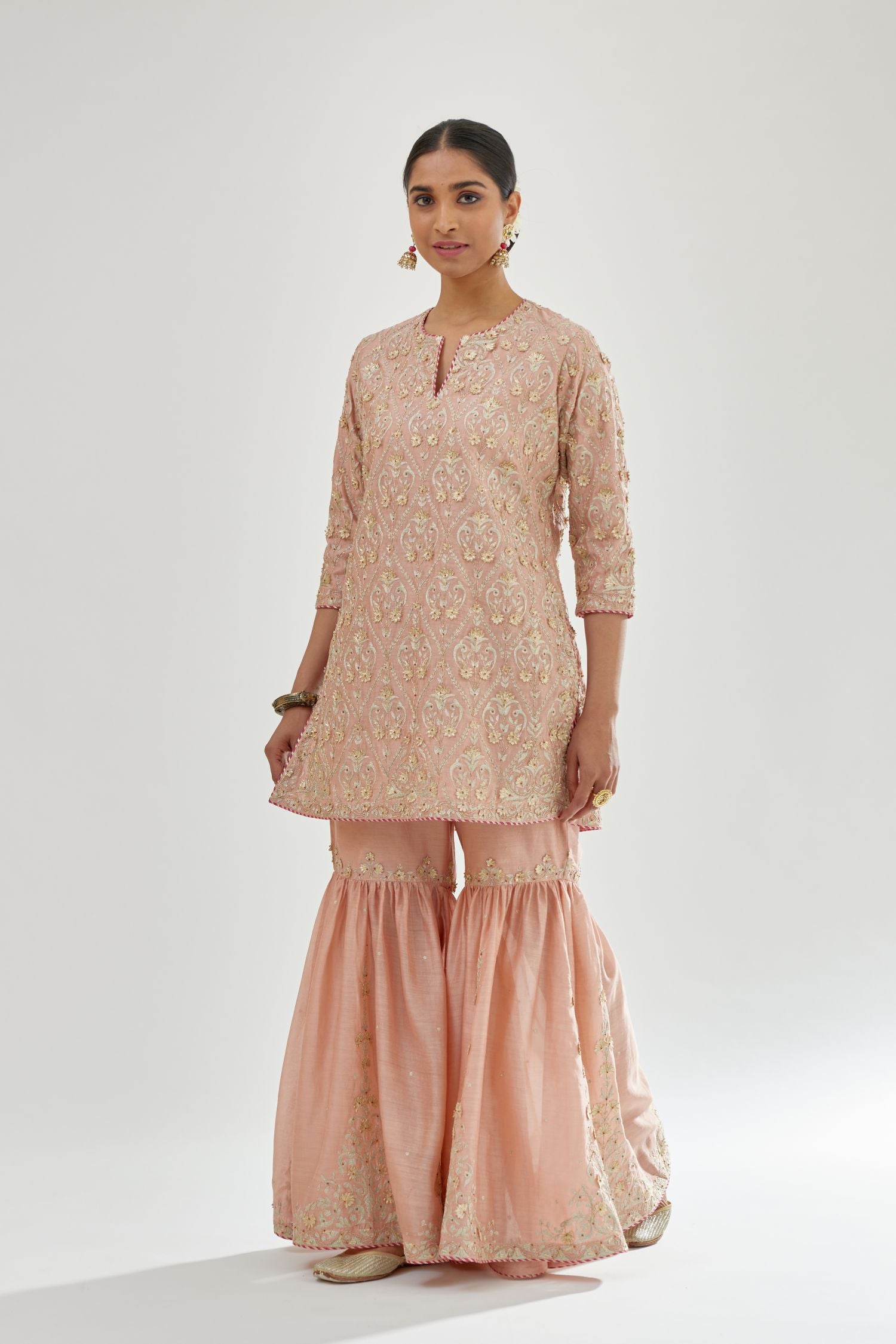 Pink short kurta set detailed with all-over zari, dori, sequins and gota embroidery.