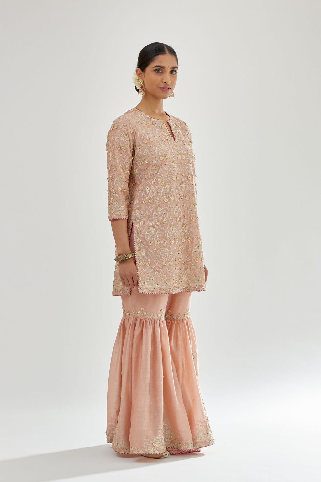 Pink short kurta set detailed with all-over zari, dori, sequins and gota embroidery.