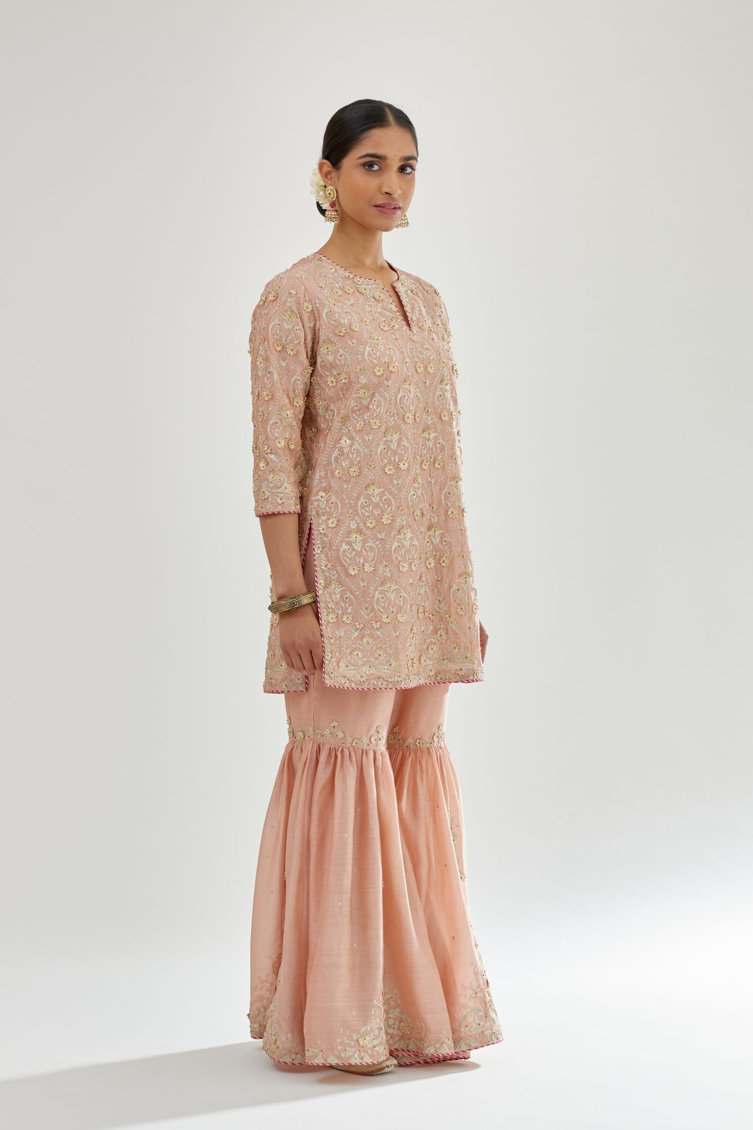 Pink short kurta set detailed with all-over zari, dori, sequins and gota embroidery.