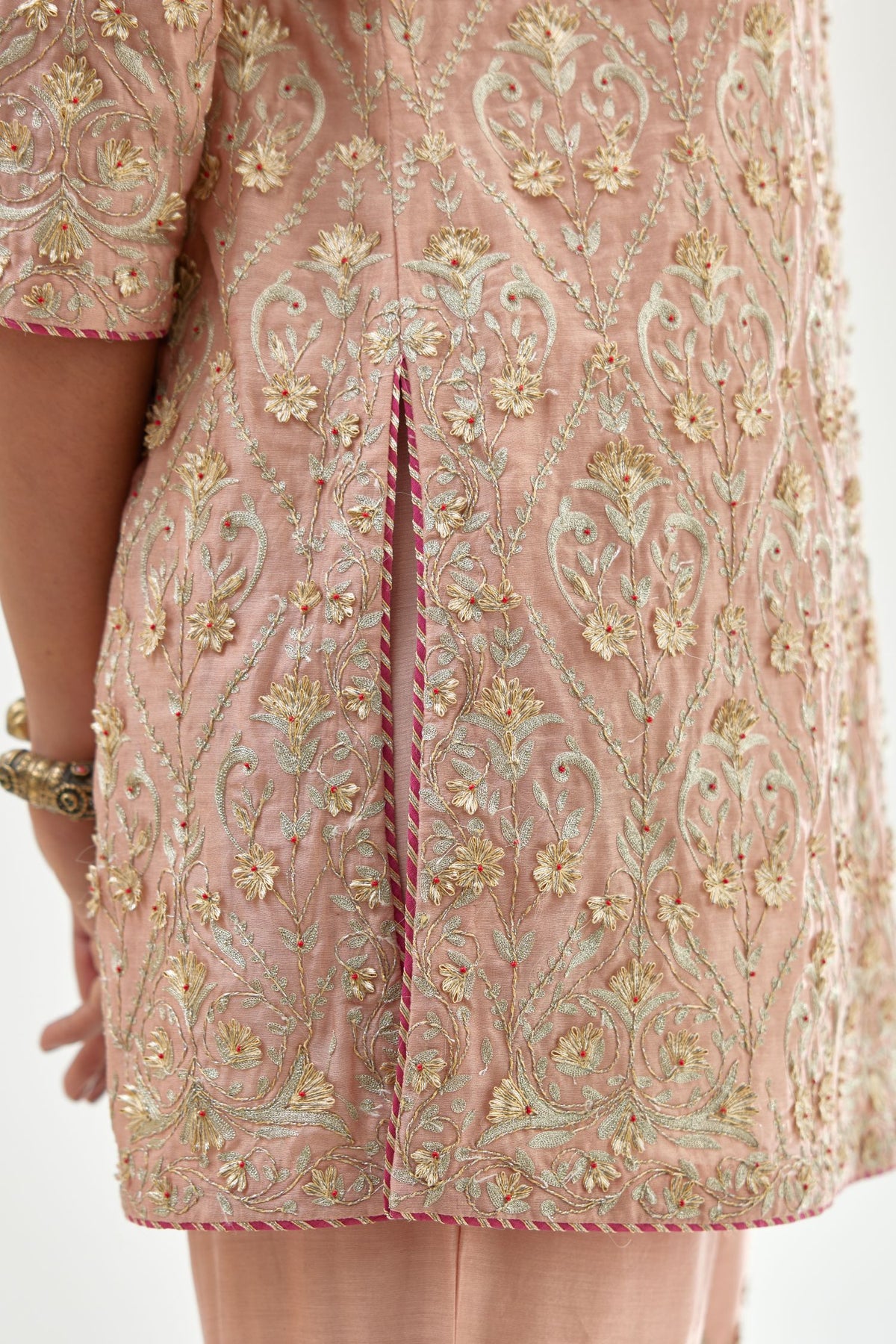 Pink short kurta set detailed with all-over zari, dori, sequins and gota embroidery.