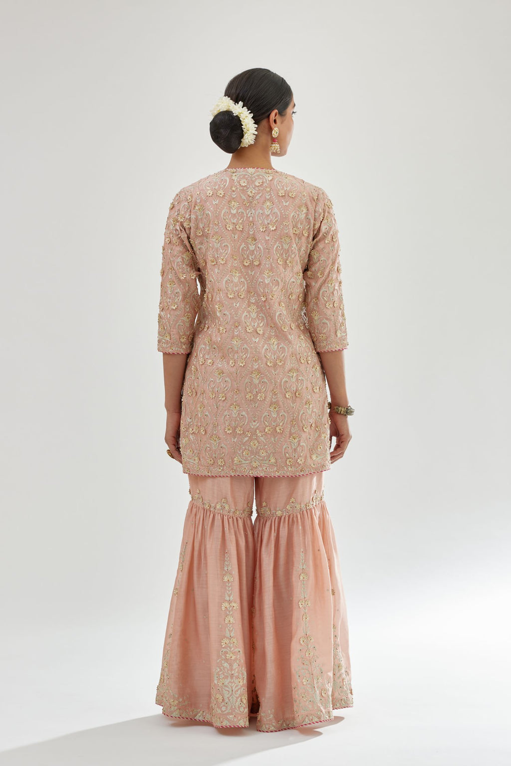 Pink short kurta set detailed with all-over zari, dori, sequins and gota embroidery.