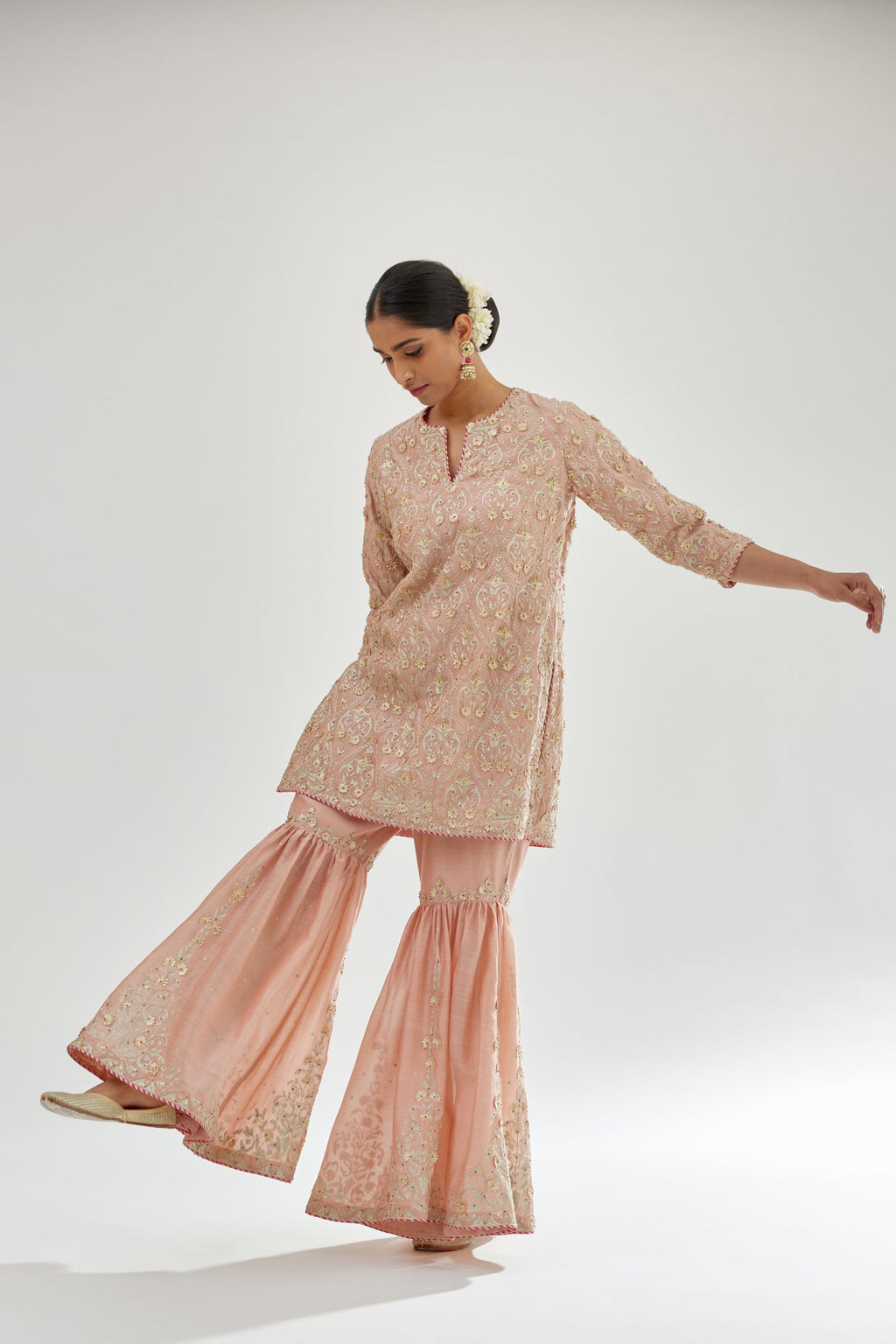 Pink short kurta set detailed with all-over zari, dori, sequins and gota embroidery.