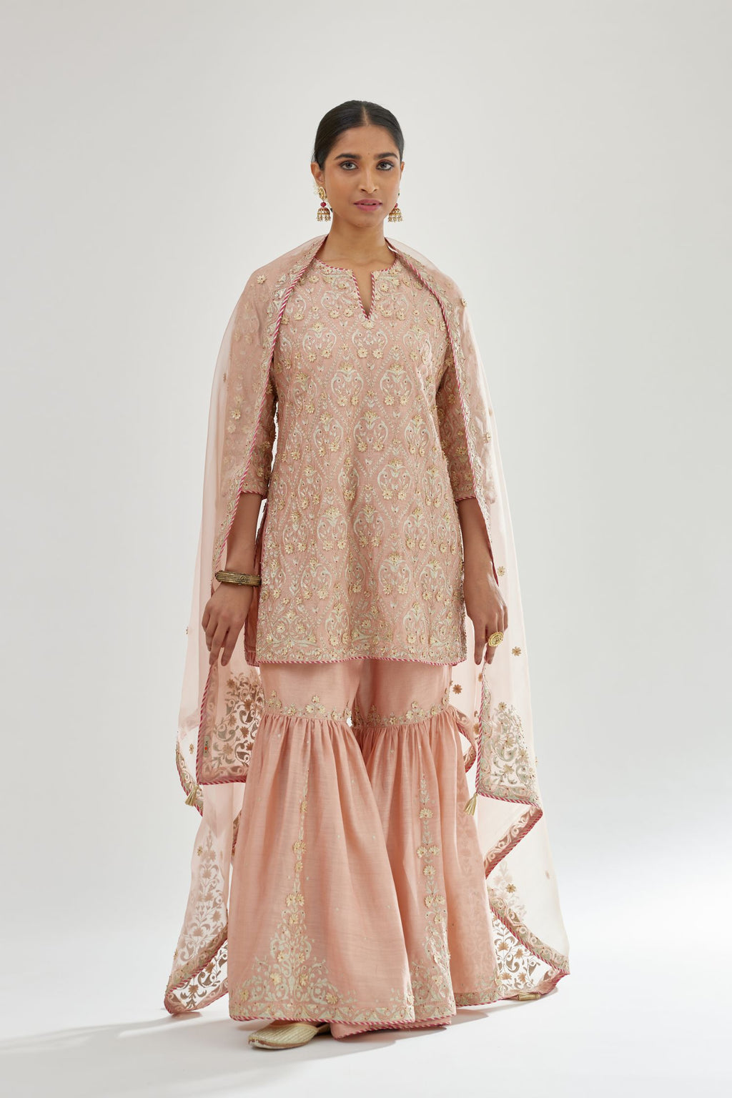 Pink short kurta set detailed with all-over zari, dori, sequins and gota embroidery.