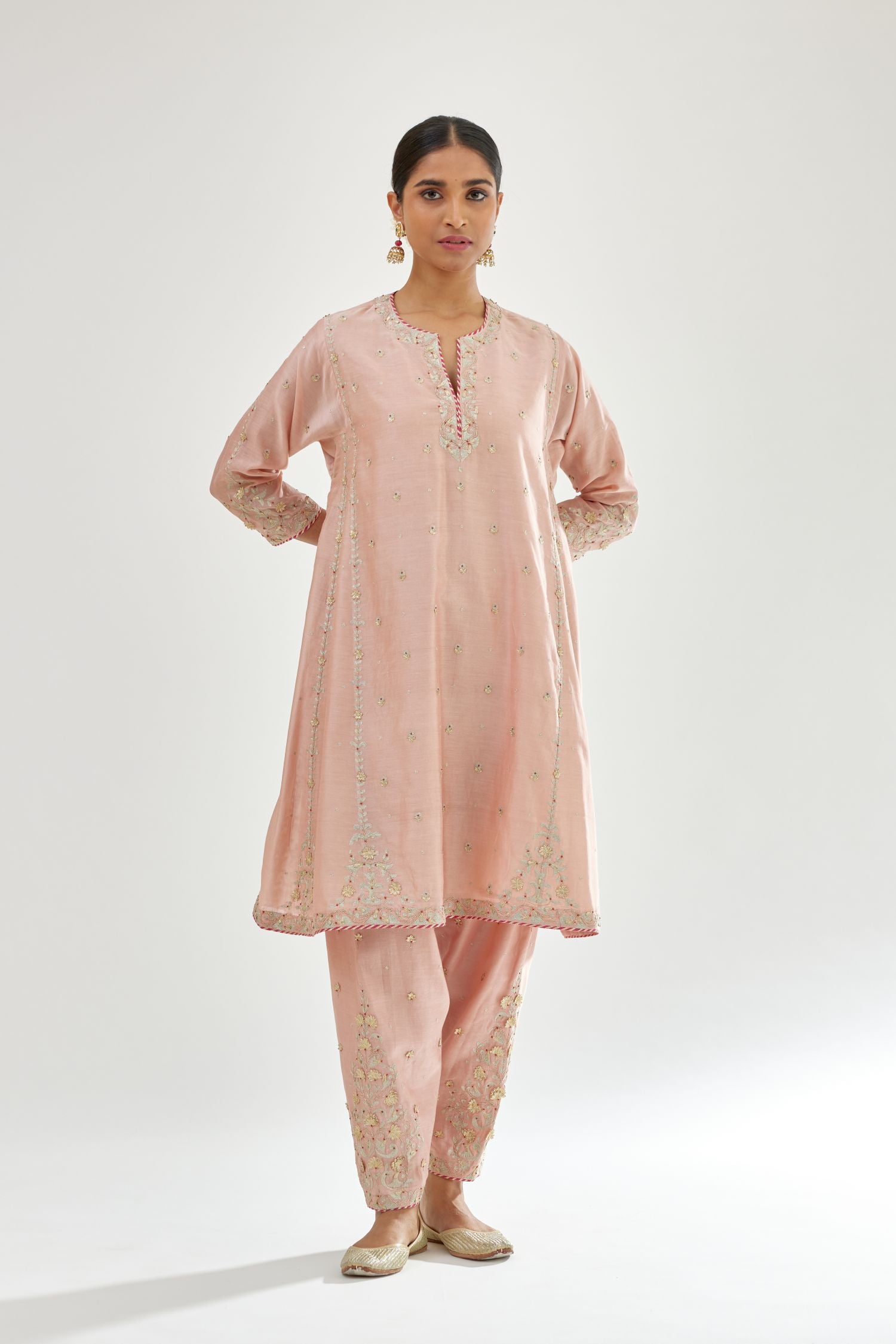 Pink silk chanderi short kalidar kurta set with all-over delicate zari bootis, detailed with dori embroidery and contrast bead work.