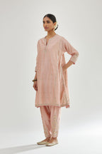 Pink silk chanderi short kalidar kurta set with all-over delicate zari bootis, detailed with dori embroidery and contrast bead work.