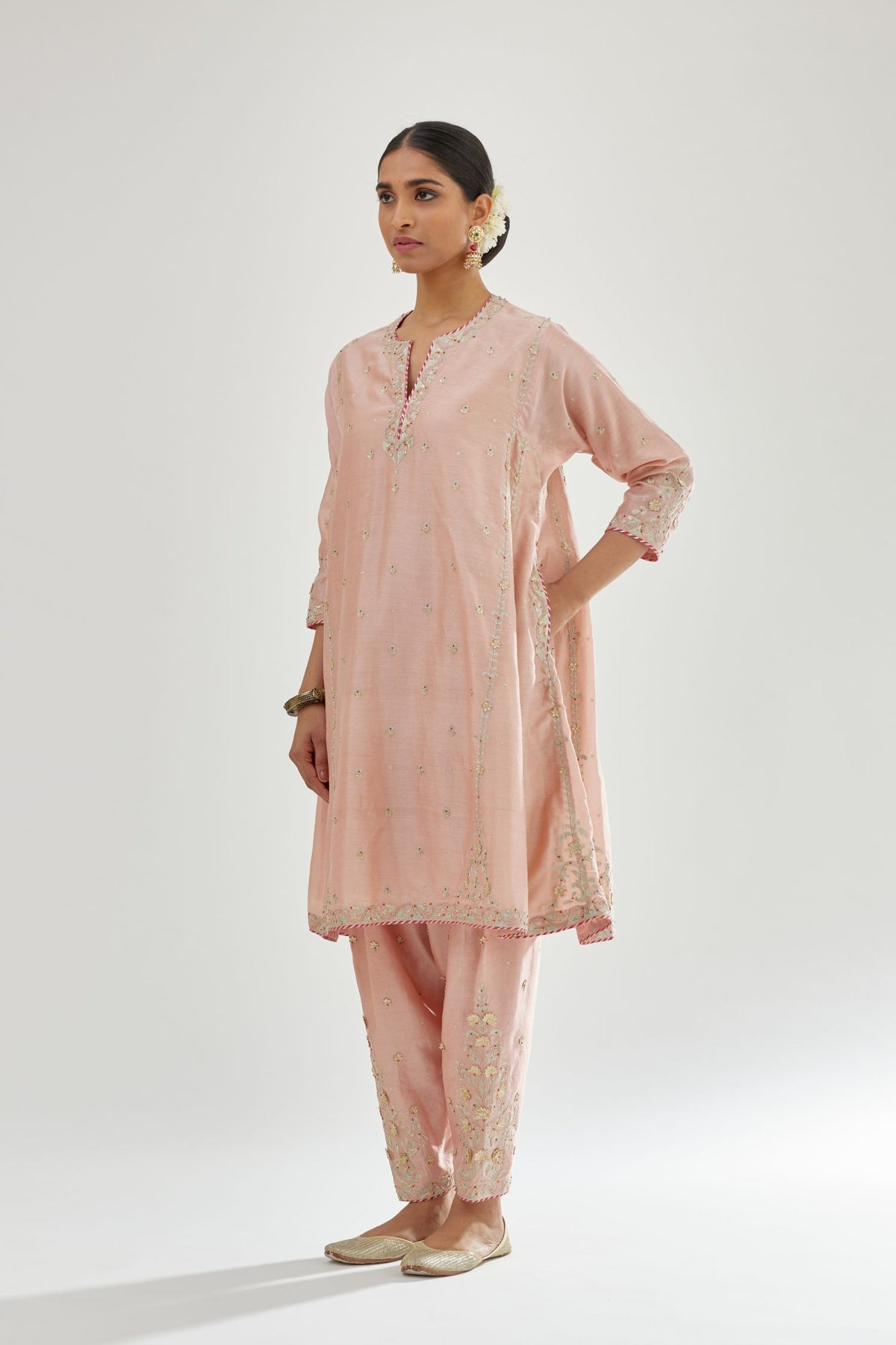 Pink silk chanderi short kalidar kurta set with all-over delicate zari bootis, detailed with dori embroidery and contrast bead work.