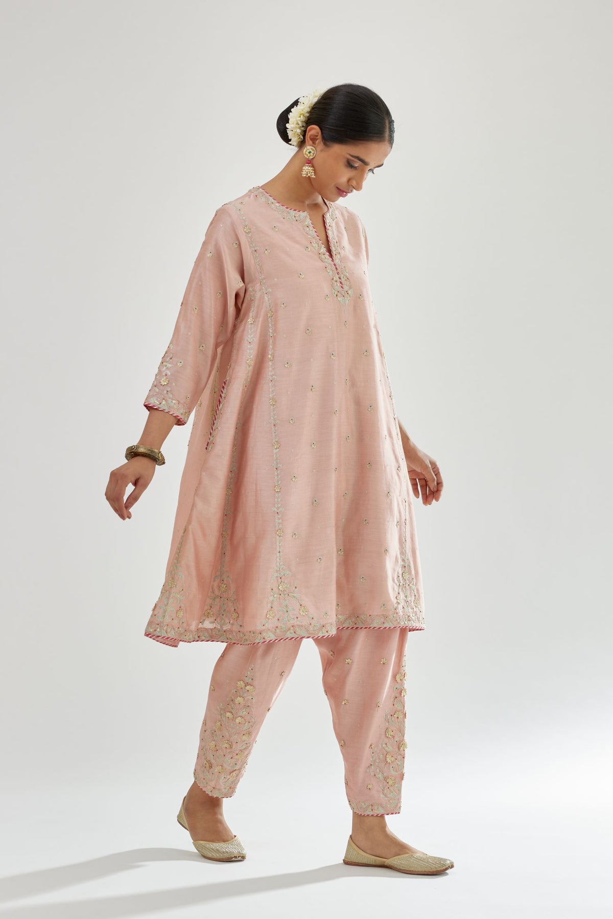 Pink silk chanderi short kalidar kurta set with all-over delicate zari bootis, detailed with dori embroidery and contrast bead work.