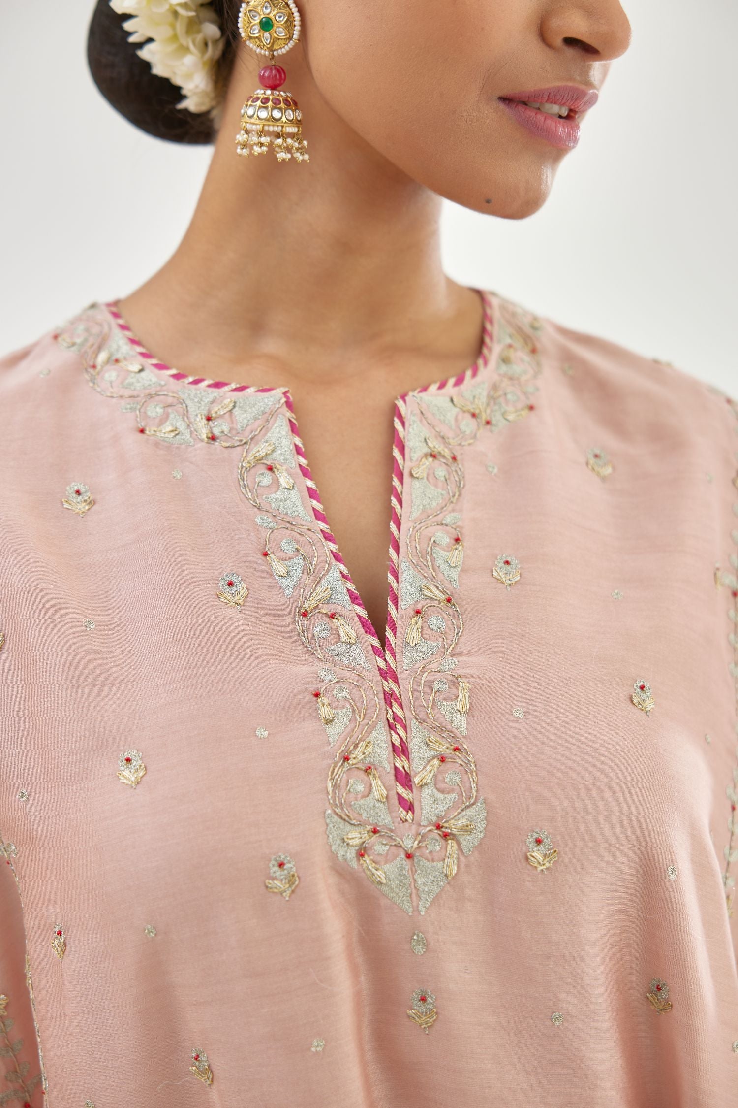Pink silk chanderi short kalidar kurta set with all-over delicate zari bootis, detailed with dori embroidery and contrast bead work.