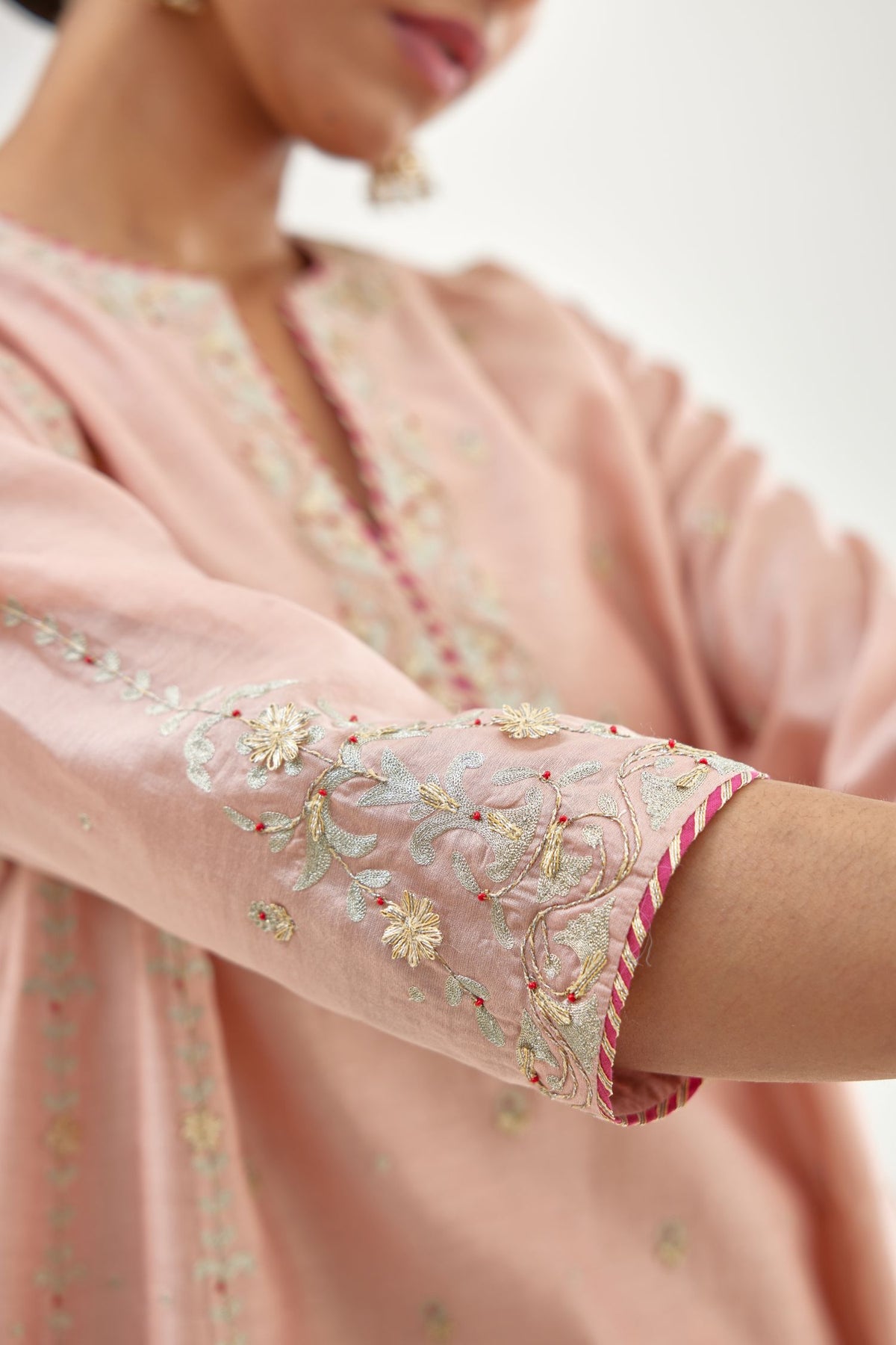 Pink silk chanderi short kalidar kurta set with all-over delicate zari bootis, detailed with dori embroidery and contrast bead work.