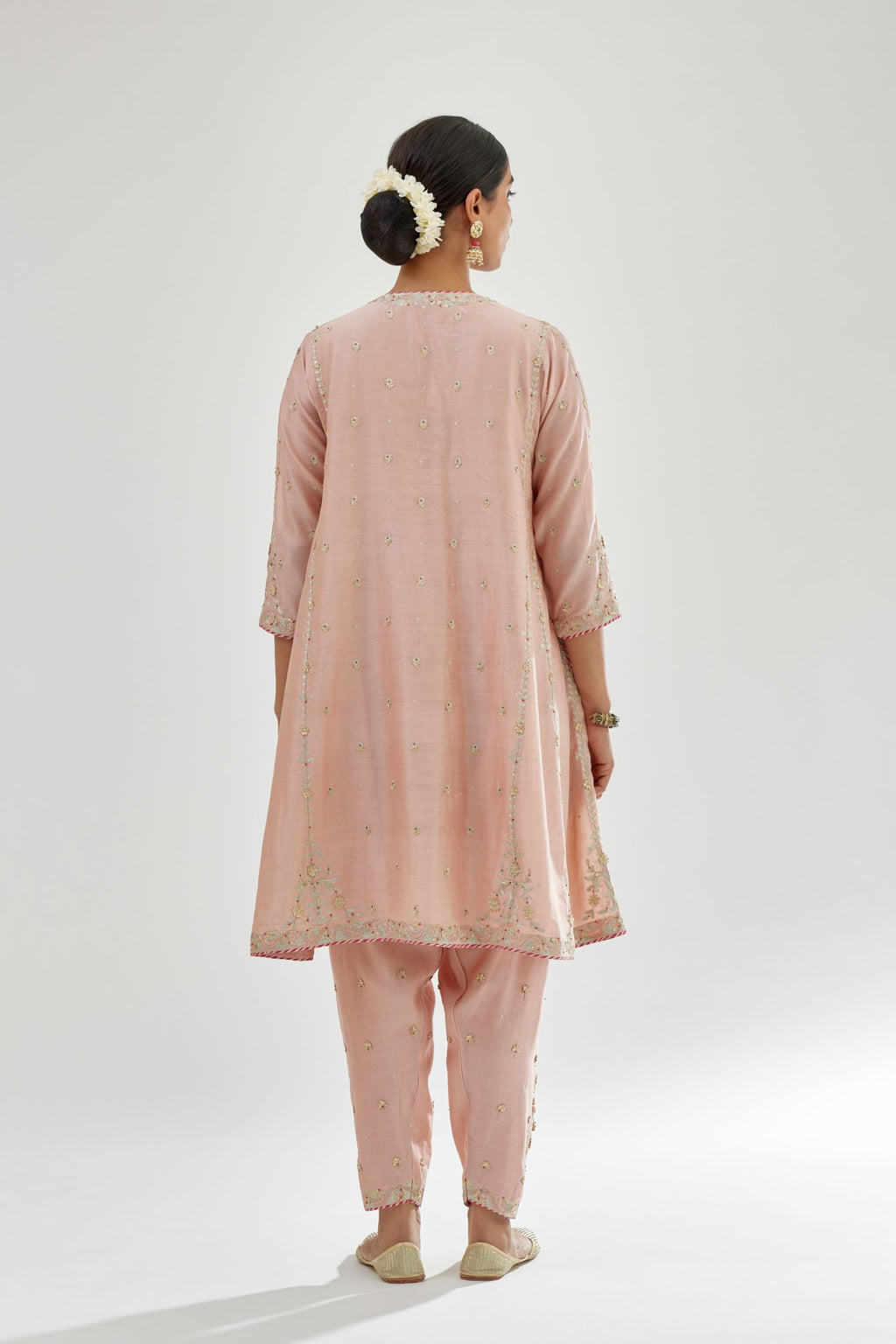 Pink silk chanderi short kalidar kurta set with all-over delicate zari bootis, detailed with dori embroidery and contrast bead work.