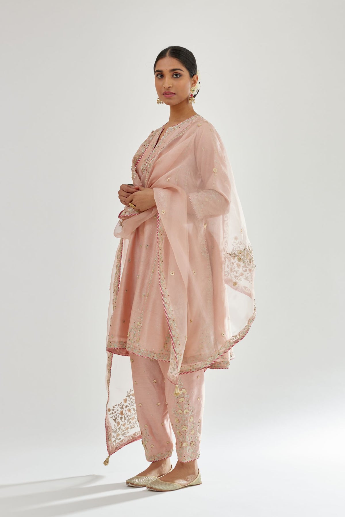 Pink silk chanderi short kalidar kurta set with all-over delicate zari bootis, detailed with dori embroidery and contrast bead work.