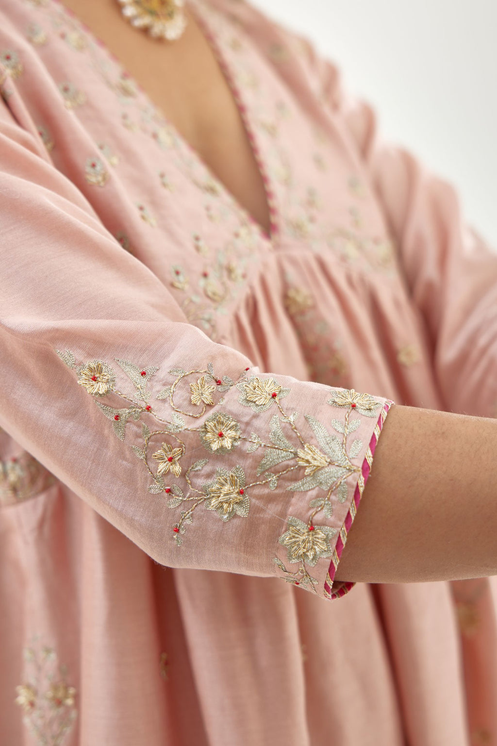 Pink silk chanderi kurta-dress set with zari, dori and gota embroidery, highlighted with contrast bead work.