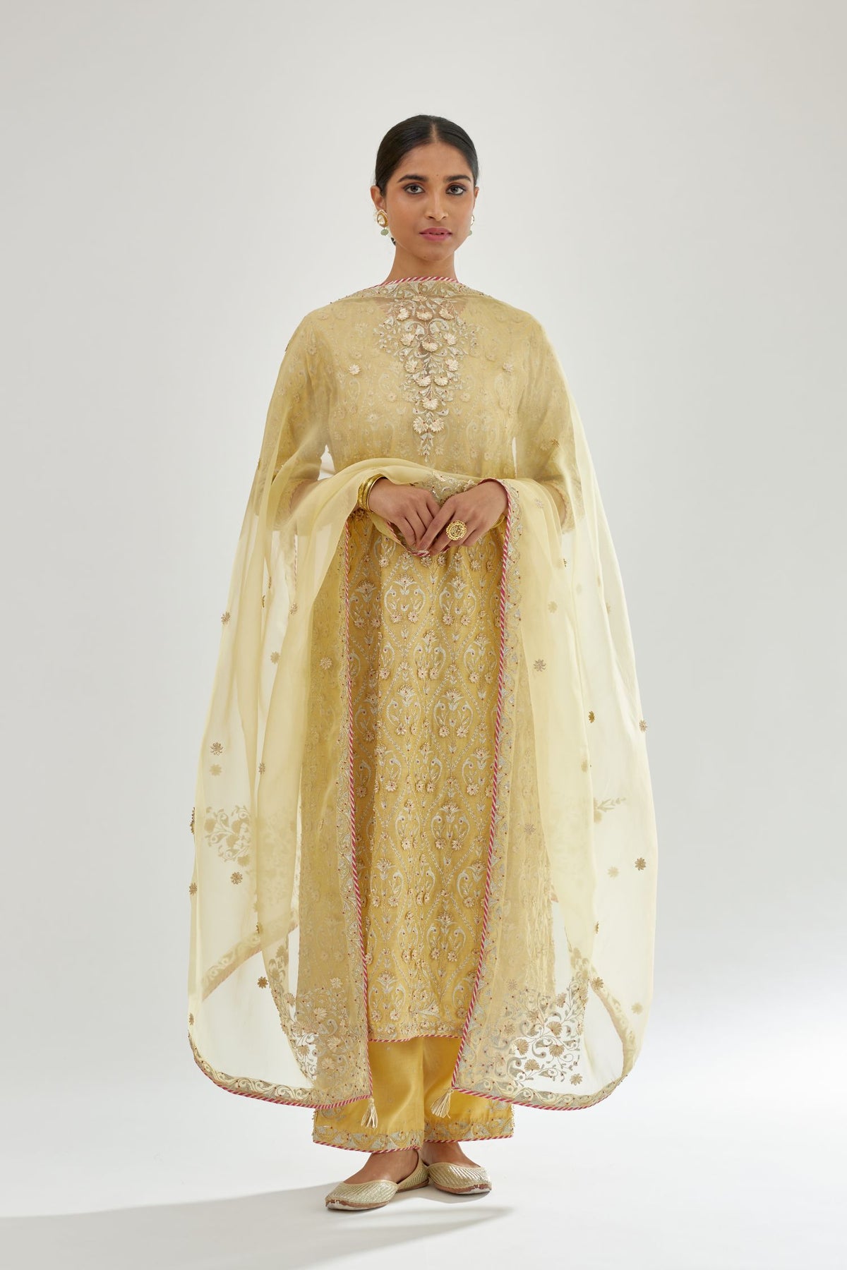 Yellow silk organza dupatta with dori and gota embroidery at edges, highlighted with contrast bead work.