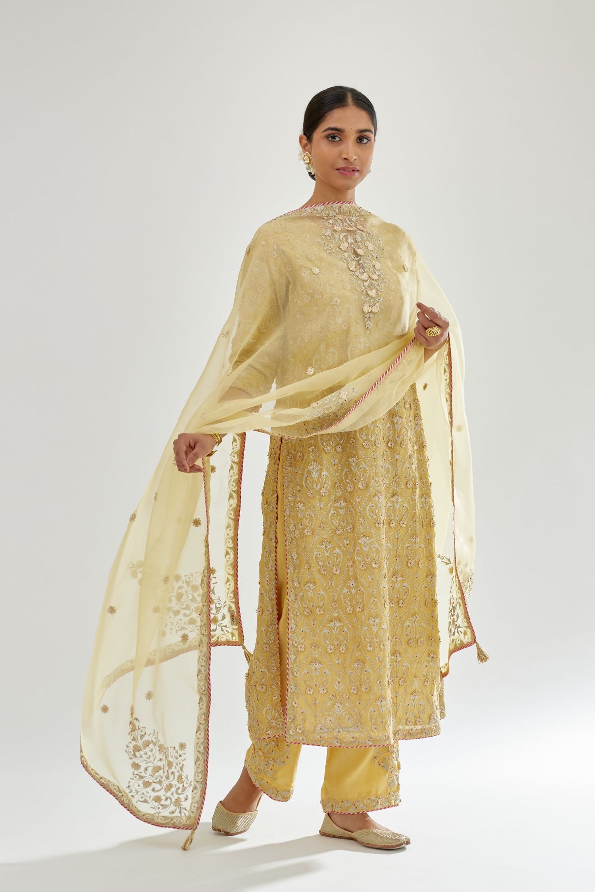 Yellow silk organza dupatta with dori and gota embroidery at edges, highlighted with contrast bead work.