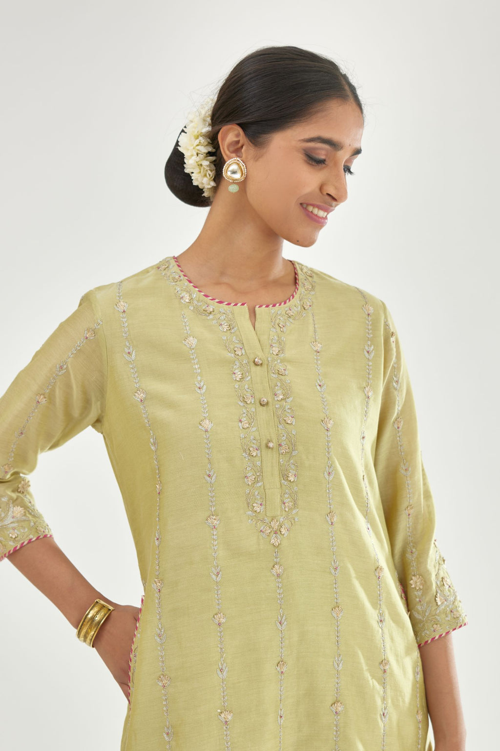 Green silk chanderi straight kurta set with all over heavy dori and gota embroidery work, highlighted with contrast bead work.