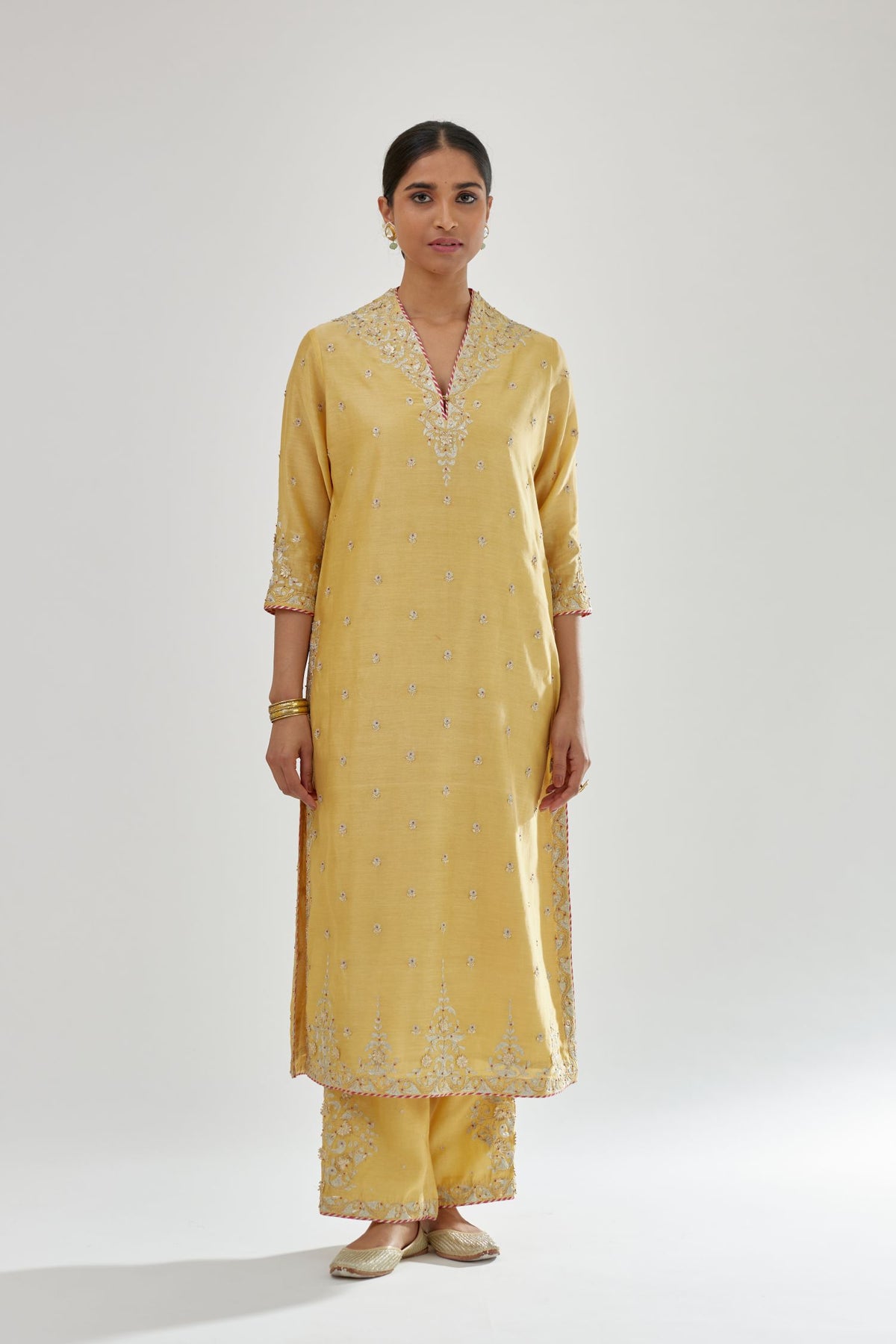 Yellow silk chanderi straight kurta set with zari, dori and gota embroidery, detailed with all-over delicate aari embroidery buties.