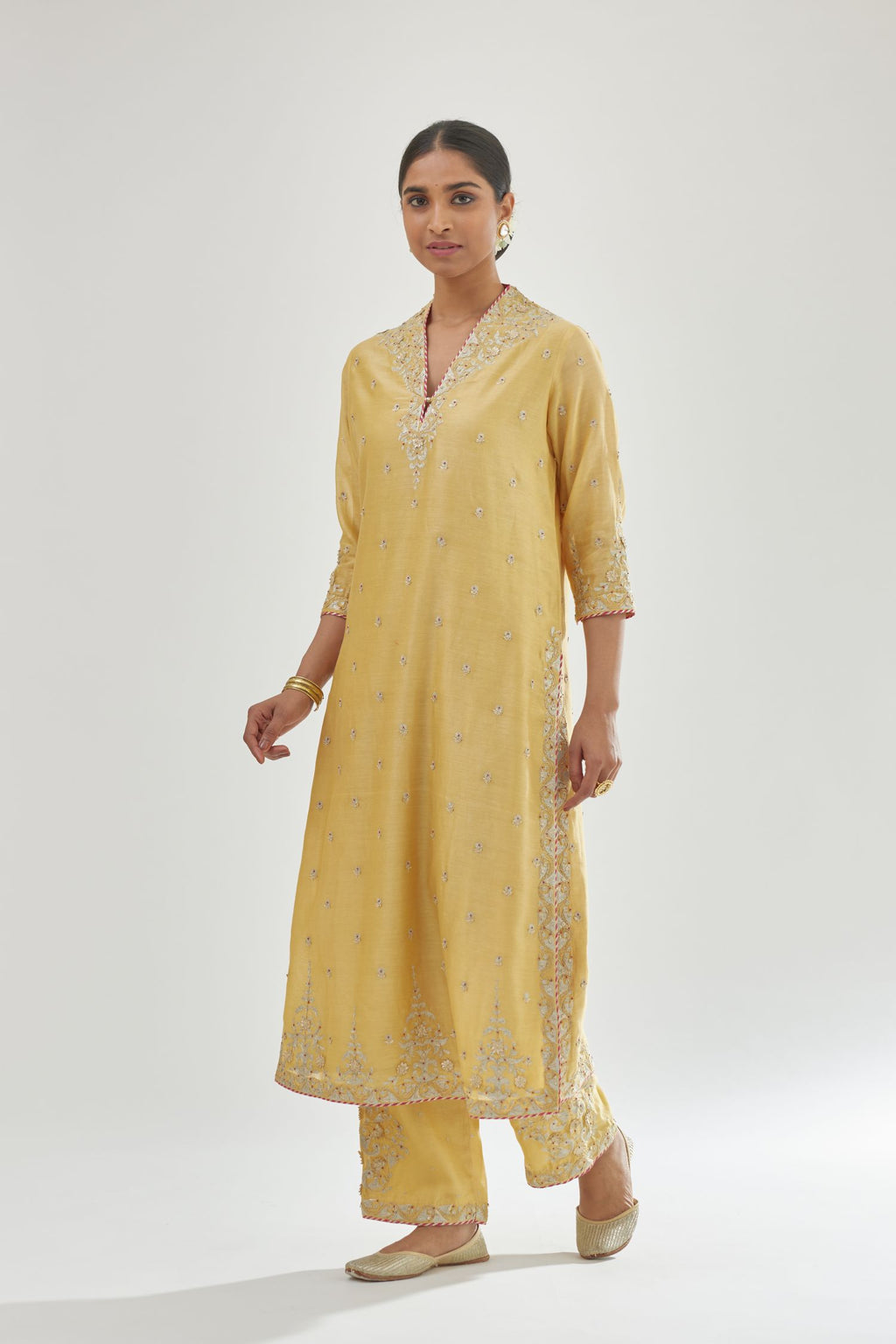 Yellow silk chanderi straight kurta set with zari, dori and gota embroidery, detailed with all-over delicate aari embroidery buties.