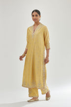 Yellow silk chanderi straight kurta set with zari, dori and gota embroidery, detailed with all-over delicate aari embroidery buties.