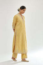 Yellow silk chanderi straight kurta set with zari, dori and gota embroidery, detailed with all-over delicate aari embroidery buties.