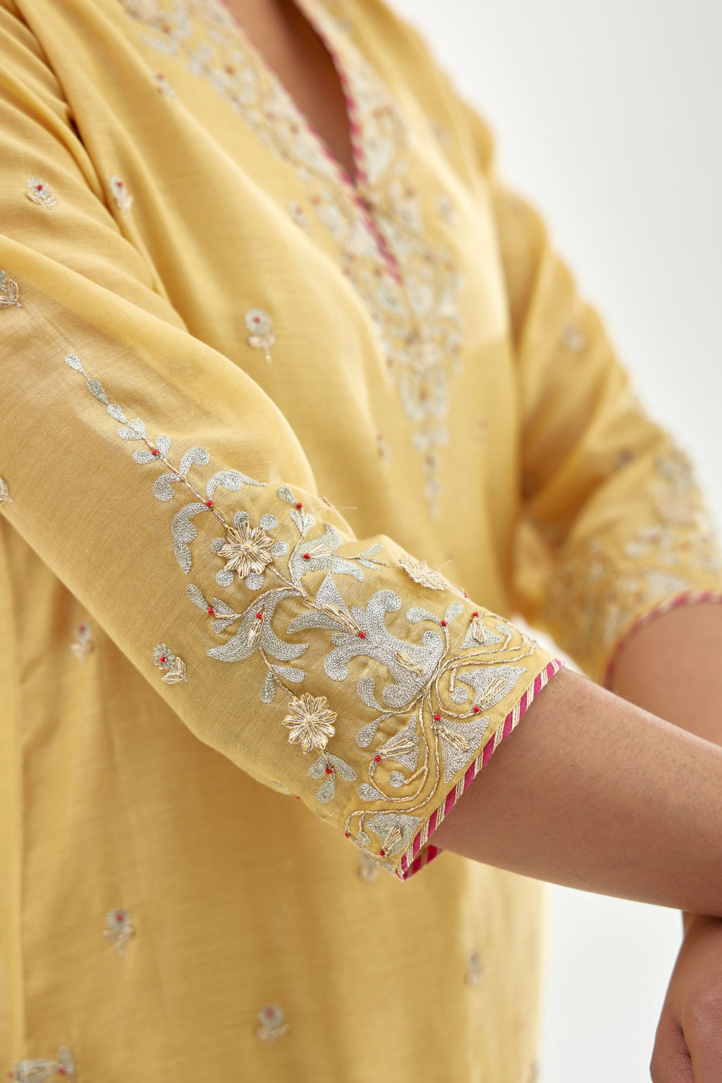 Yellow silk chanderi straight kurta set with zari, dori and gota embroidery, detailed with all-over delicate aari embroidery buties.