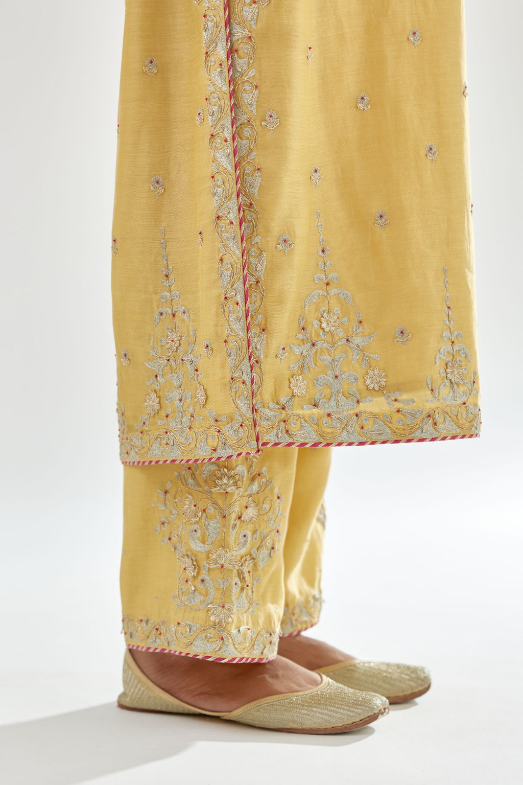 Yellow silk chanderi straight kurta set with zari, dori and gota embroidery, detailed with all-over delicate aari embroidery buties.