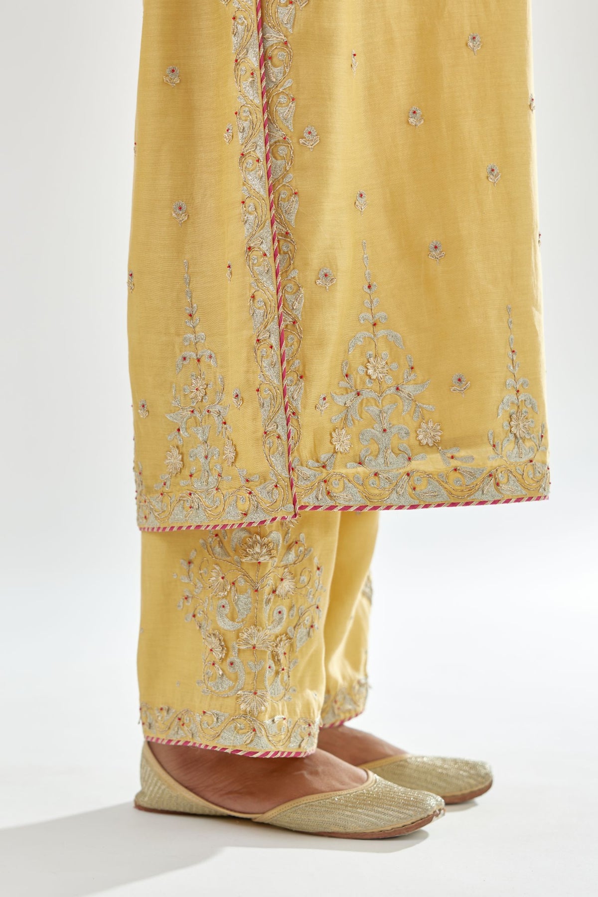 Yellow silk chanderi straight kurta set with zari, dori and gota embroidery, detailed with all-over delicate aari embroidery buties.
