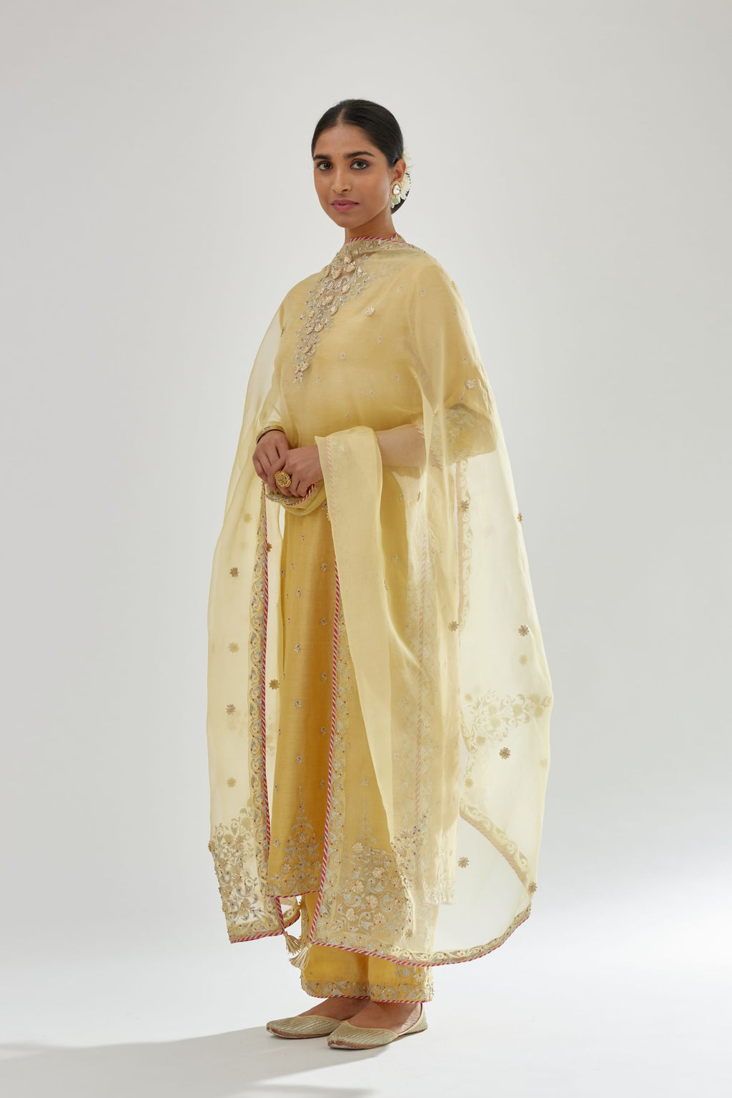 Yellow silk organza dupatta with dori and gota embroidery at edges, highlighted with contrast bead work.