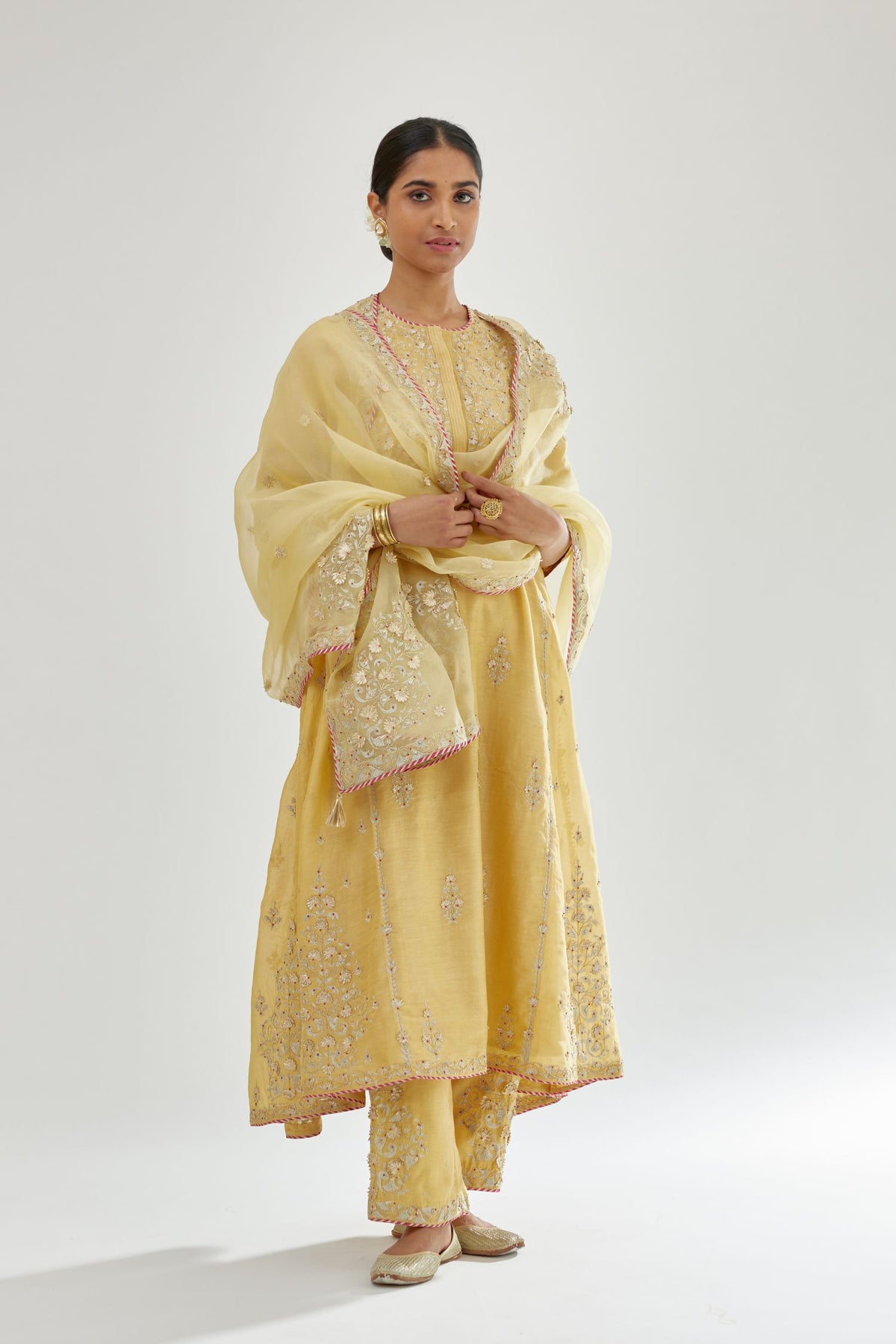 Yellow A-line long kurta set with all-over zari, dori, sequins and gota embroidery.