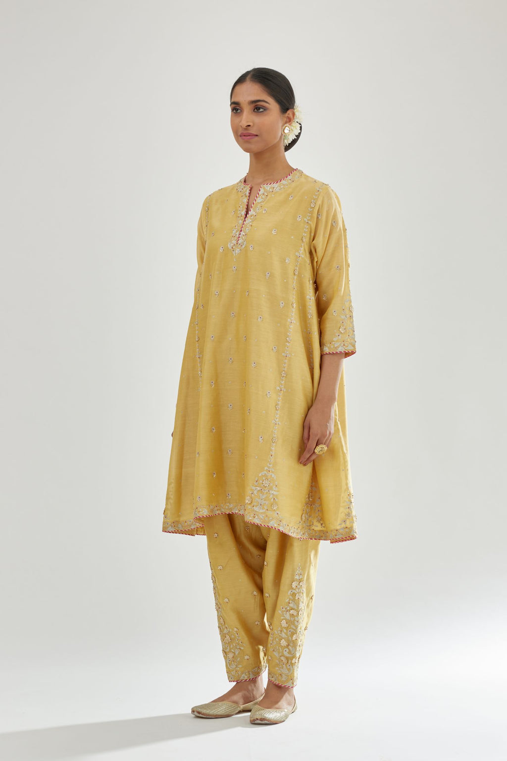 Yellow silk chanderi short kalidar kurta set with all-over delicate zari bootis, detailed with dori embroidery and contrast bead work.