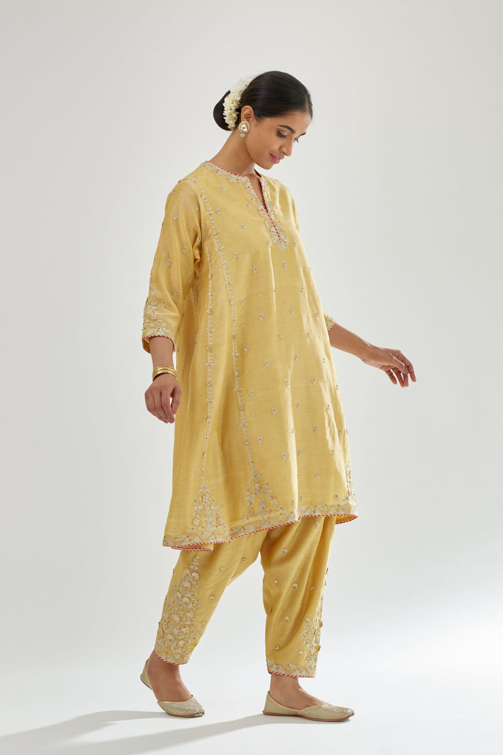 Yellow silk chanderi short kalidar kurta set with all-over delicate zari bootis, detailed with dori embroidery and contrast bead work.