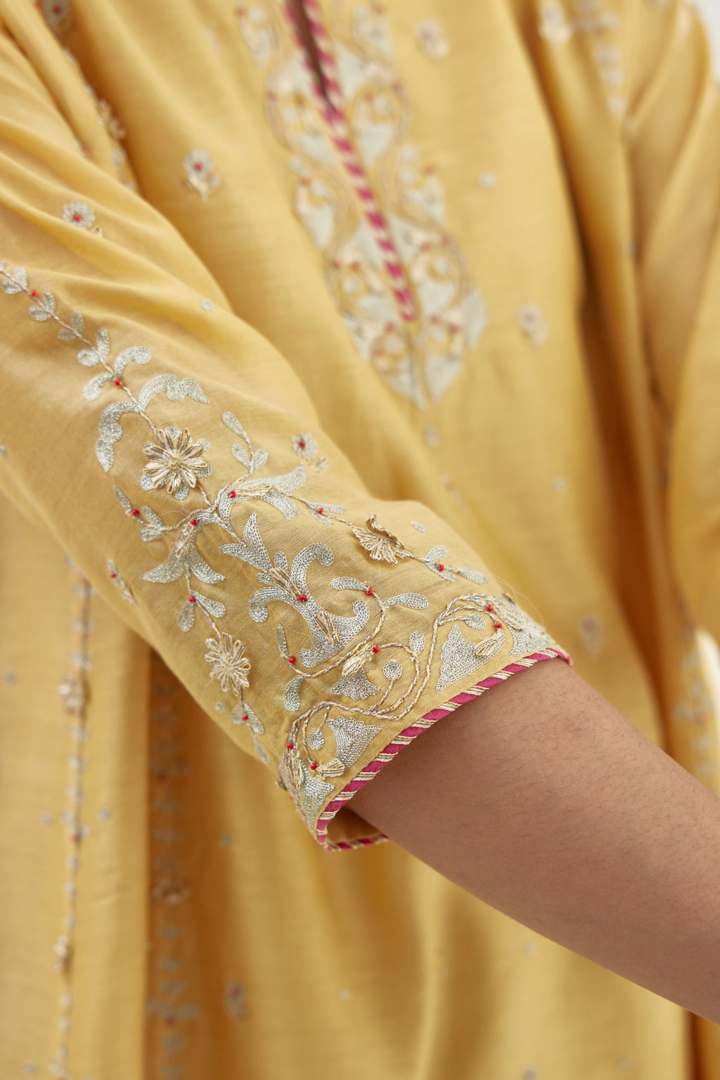 Yellow silk chanderi short kalidar kurta set with all-over delicate zari bootis, detailed with dori embroidery and contrast bead work.