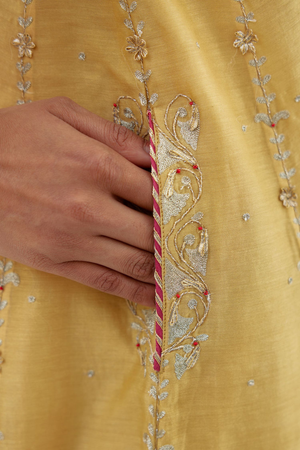 Yellow silk chanderi short kalidar kurta set with all-over delicate zari bootis, detailed with dori embroidery and contrast bead work.