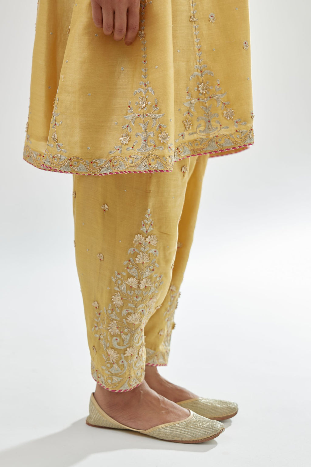 Yellow silk chanderi short kalidar kurta set with all-over delicate zari bootis, detailed with dori embroidery and contrast bead work.