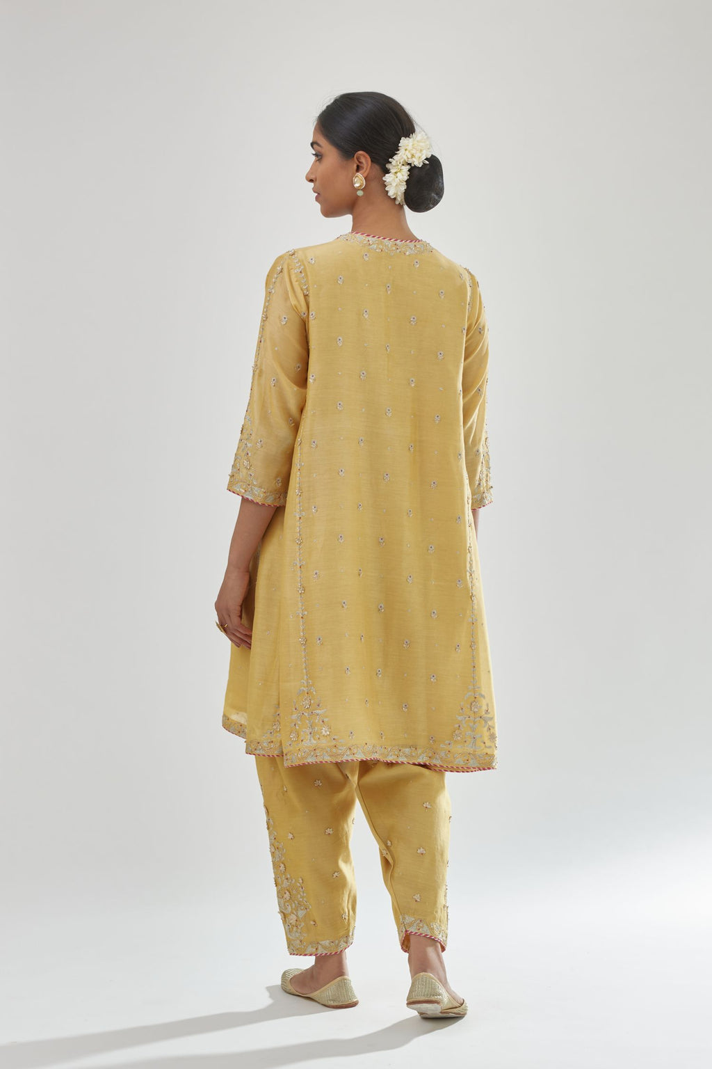 Yellow silk chanderi short kalidar kurta set with all-over delicate zari bootis, detailed with dori embroidery and contrast bead work.